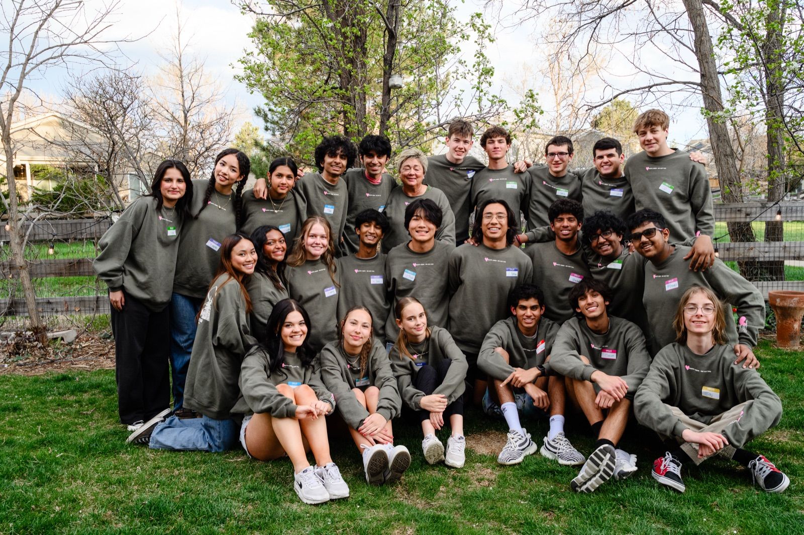 The student leaders together on a lawn with Amy, arms around each other, smiling