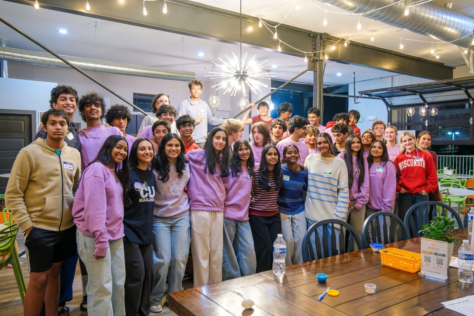 The whole crew upstairs at the coffee house in a big group photo