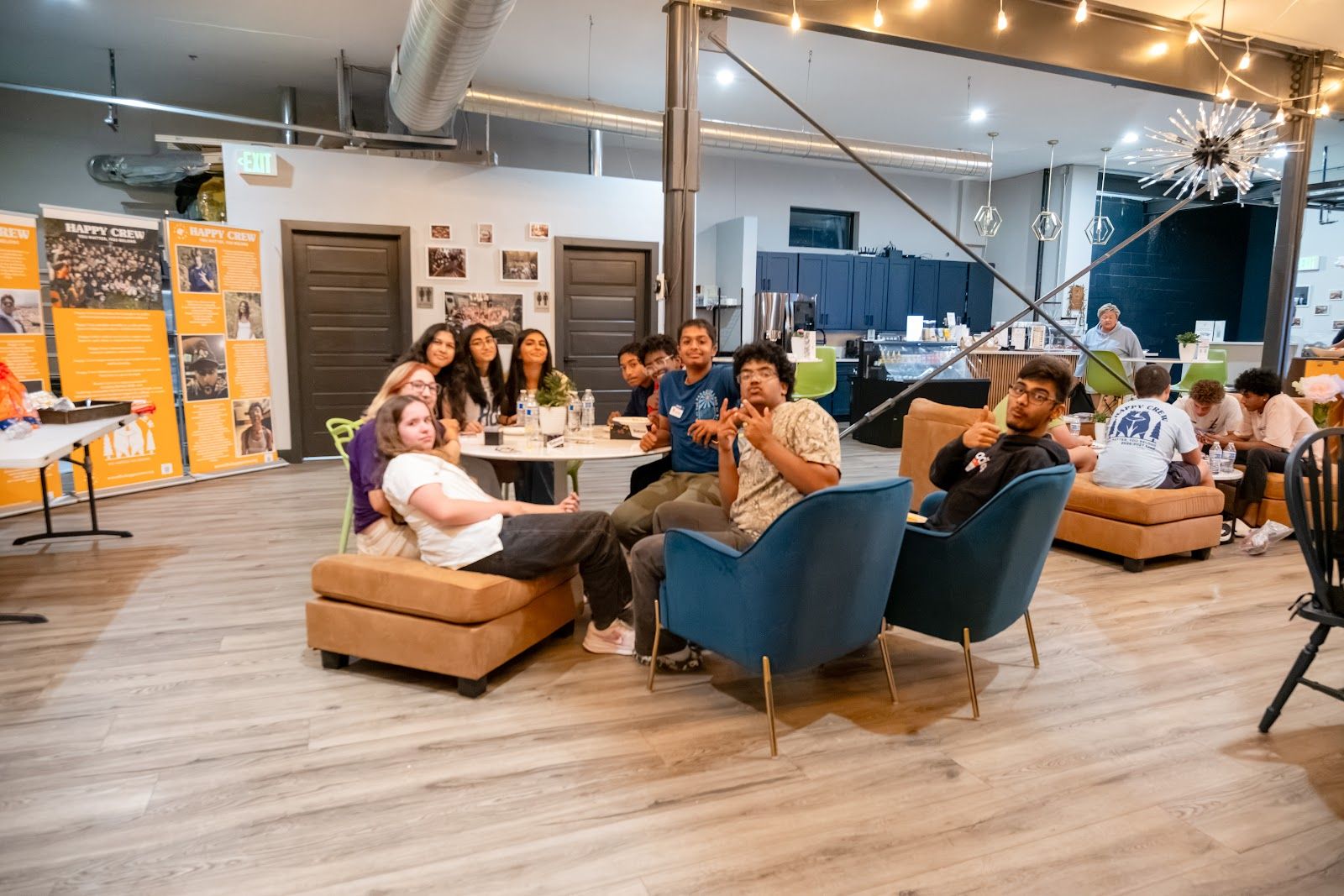 Teens around a low table on the couches at the coffee house