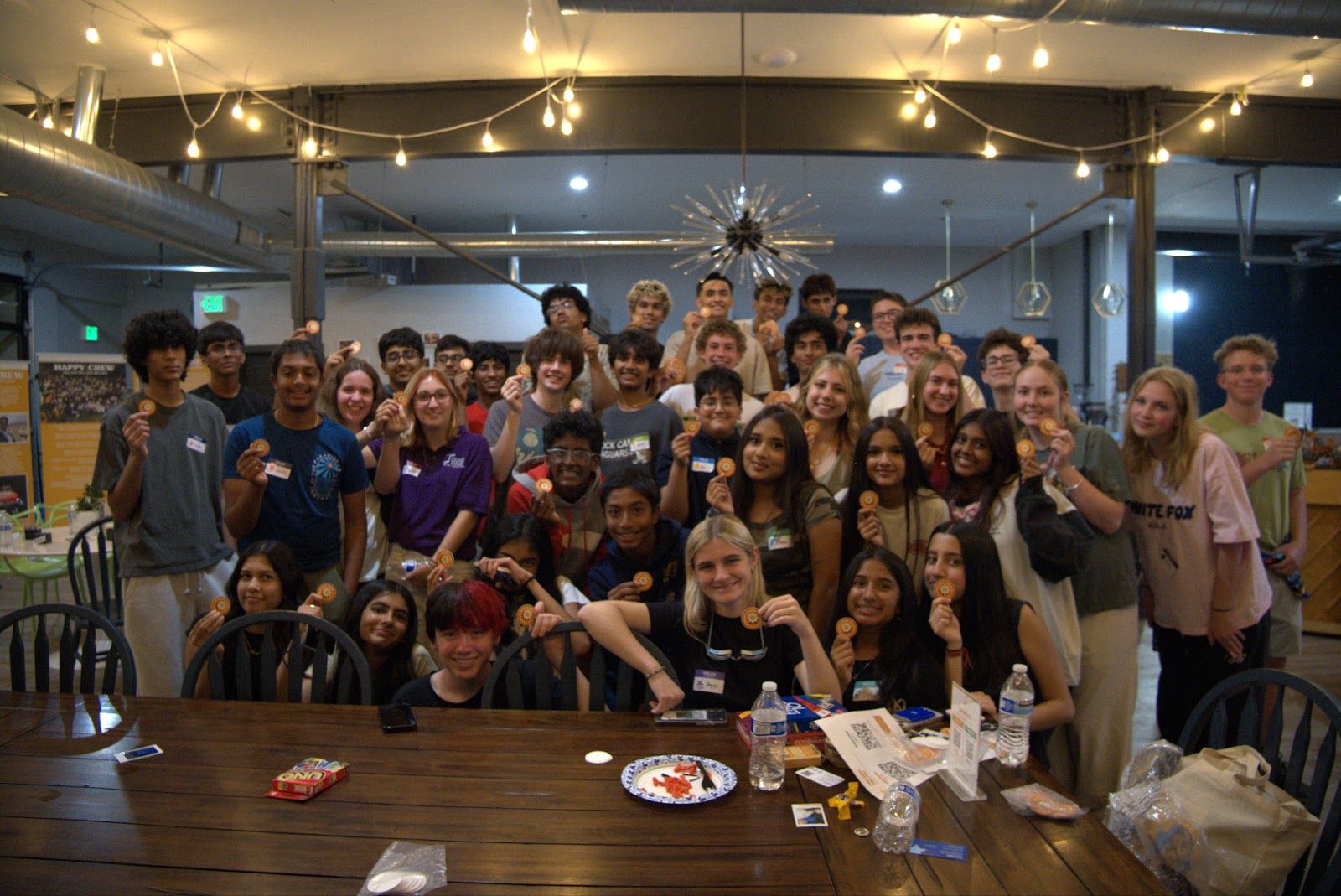 The whole crew in one group photo around the long table