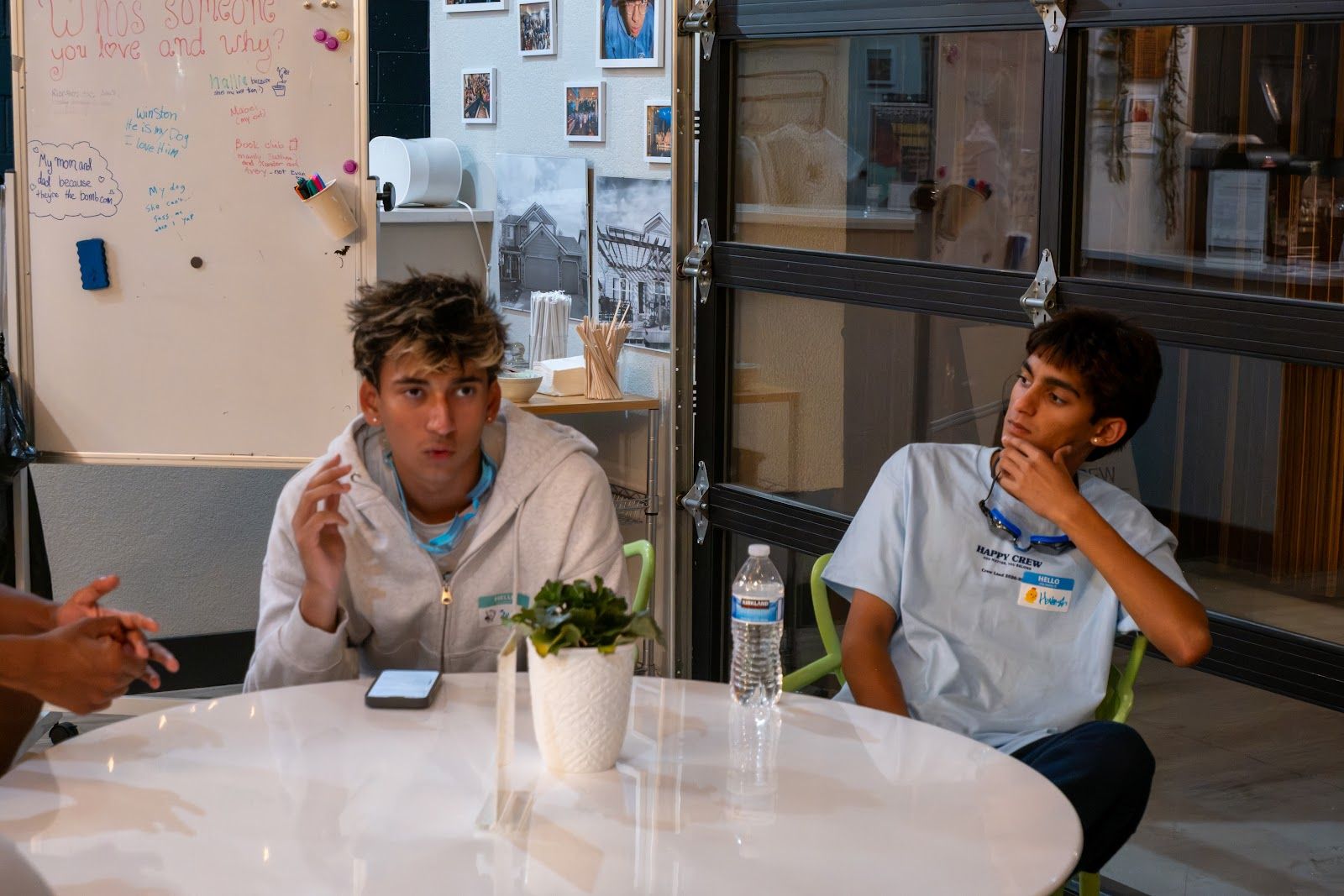 Two teens talking at a table