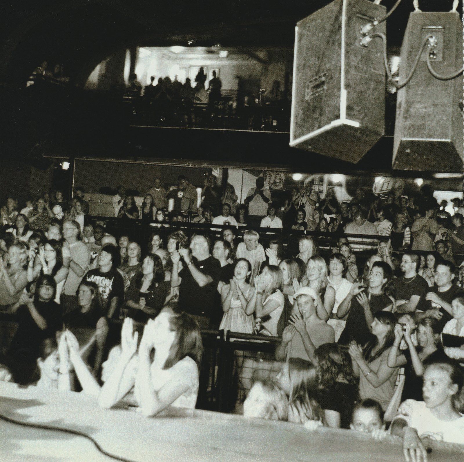A packed crowd cheering at the Gothic Theatre during Battle of the Bands, in black and white
