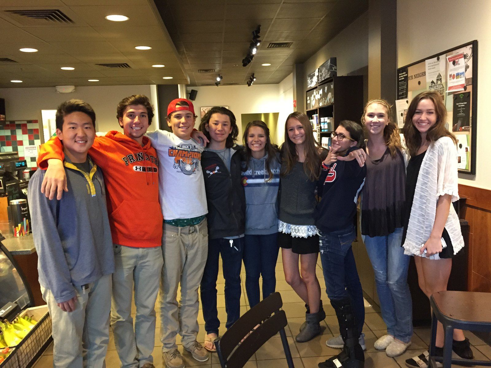 The original group who started Happy Crew, arm in arm inside a Starbucks, 2015